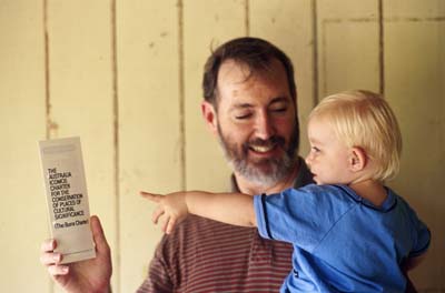 Lucy pointing to the rare, collectable, pocket edition of the Burra Charter, February 1998